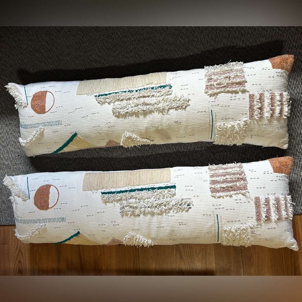 two anthropology pillows. 39inx11in